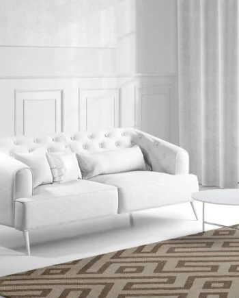 a living room with a bed and a chair in front of a window