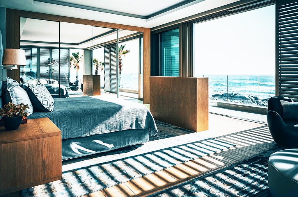 bedroom furniture on a hand made rug overlooking the ocean
