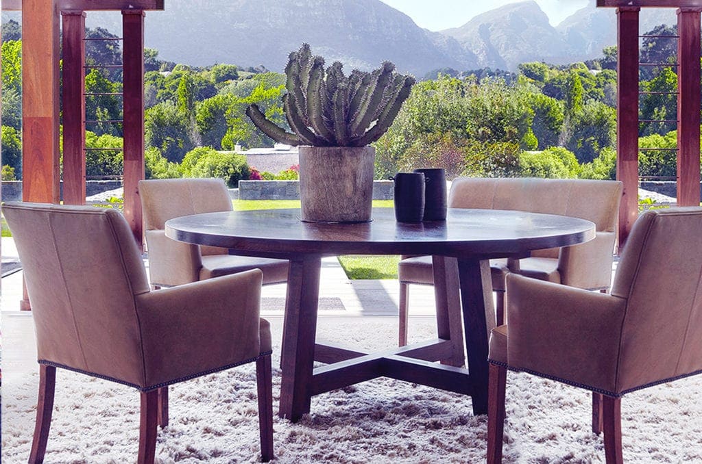 a dining table on a rug with a view of a mountain