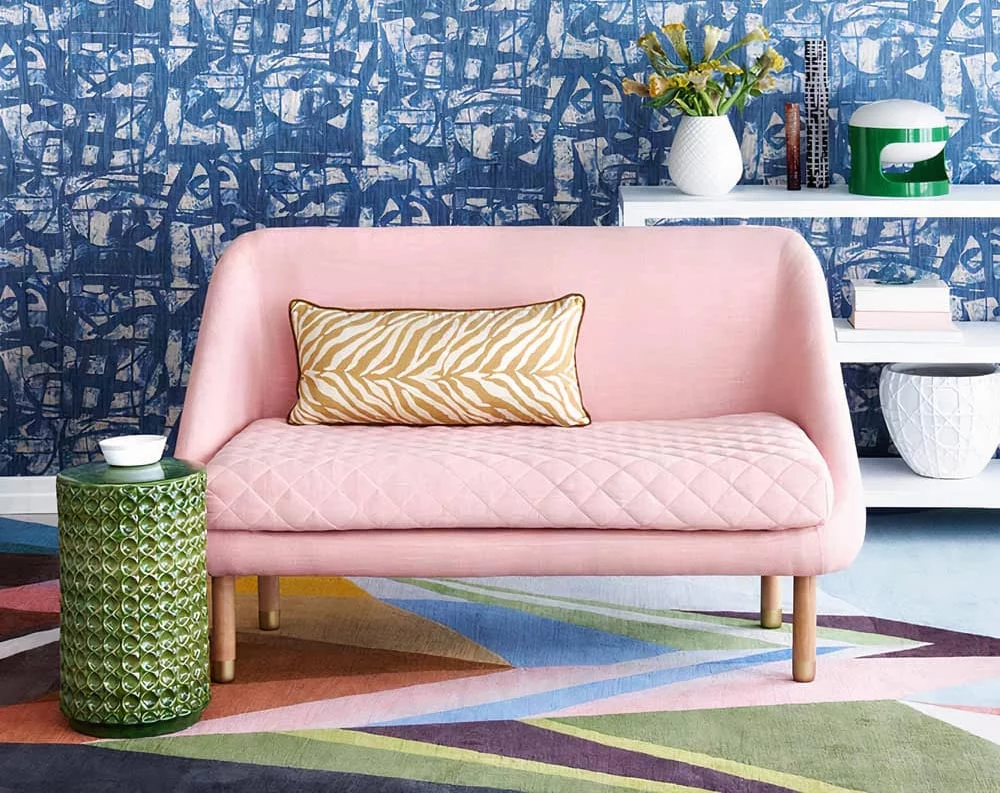 a living room with a couch and a chair on a KLUK CGDT rug