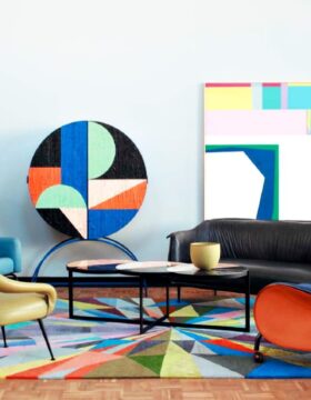 a desk with a computer and a chair in a room